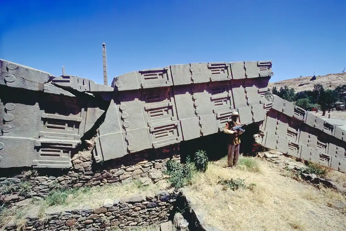 Armed guard and the tallest of the Axumite obelisks, toppled by a mad queen Armed guard and the tallest of the Axumite obelisks, toppled by a mad queen