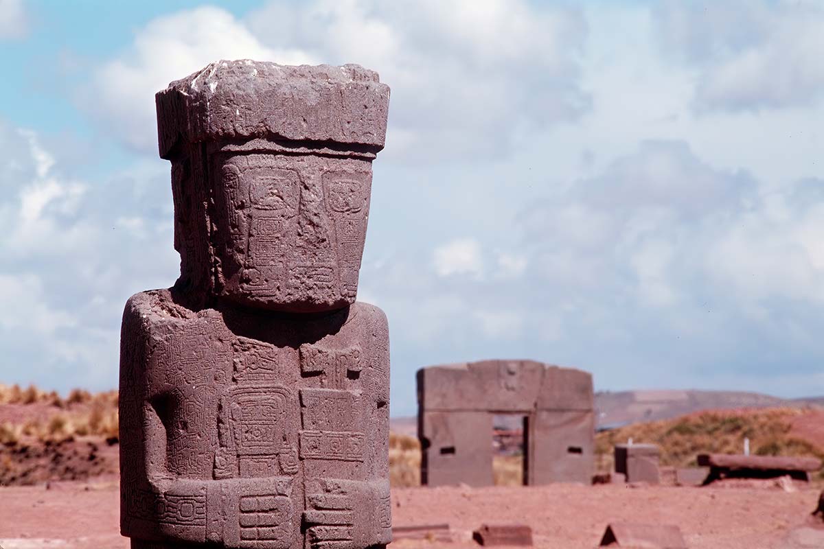 Stela 8 with Gateway of the Sun in background, Kalasasaya temple, Tiahuanaco (Tiwanaku)