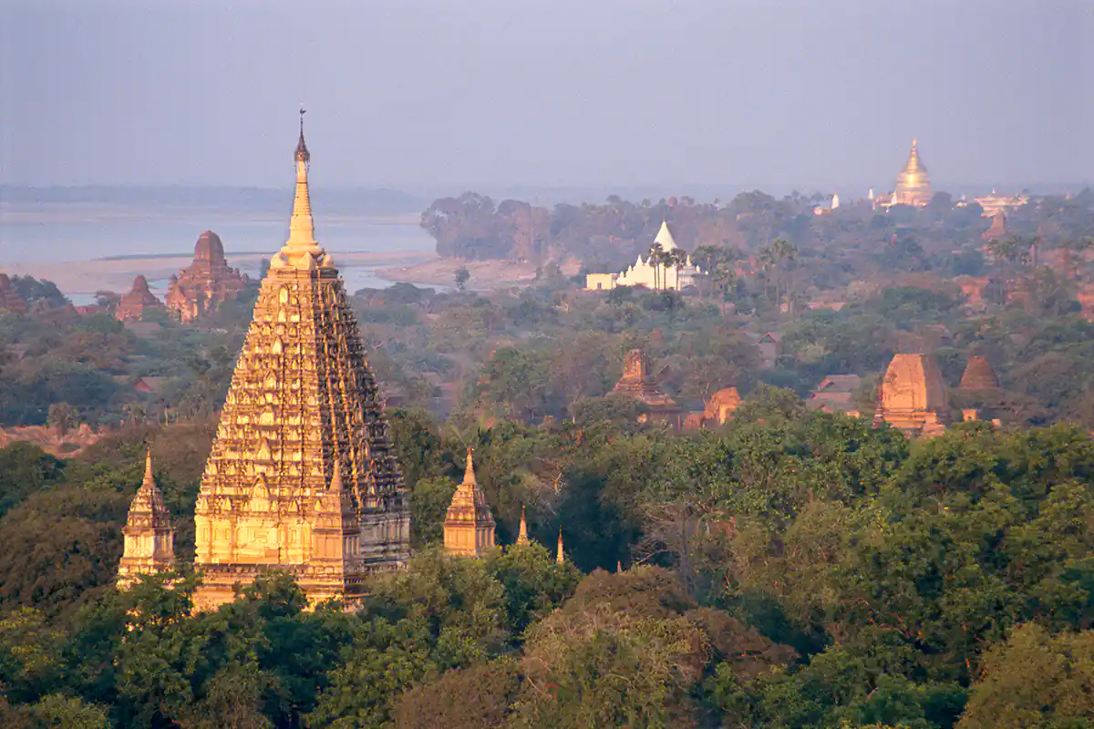 Mahabodhi Temple with golden Shwezigon in the distance Mahabodhi Temple with golden Shwezigon in the distance