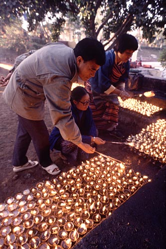 Buddhist Pilgrims lighting candles, Bodh Gaya