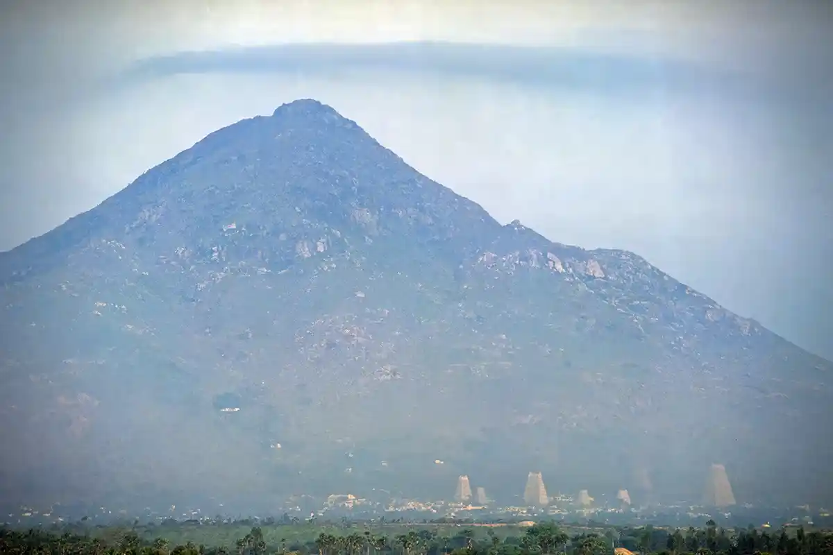 Mount Arunachala with Tiruvanamalai temple complex at the base Mount Arunachala with Tiruvanamalai temple complex at the base