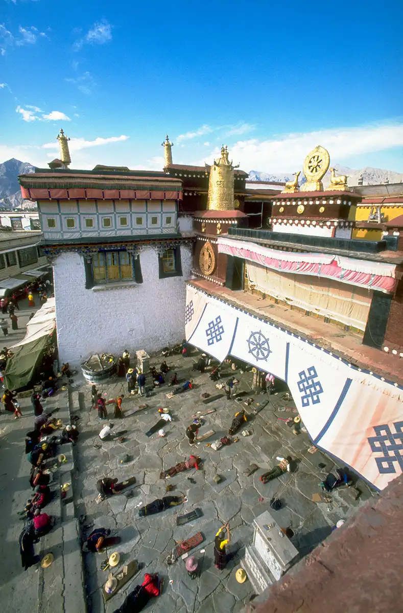 Pilgrims prostrating before entering the Johkang Temple, Lhasa, Tibet Pilgrims prostrating before entering the Johkang Temple, Lhasa, Tibet
