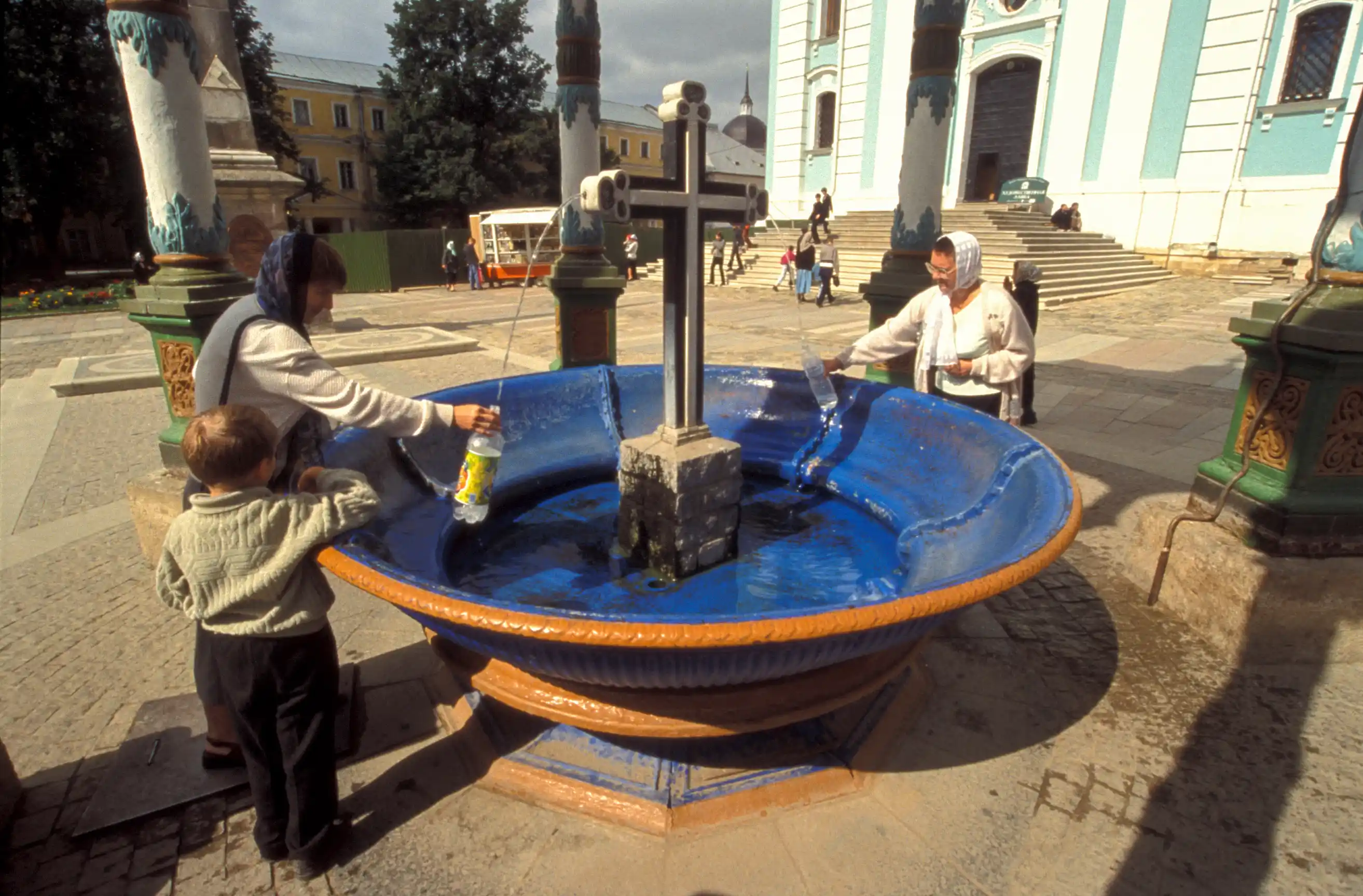 Pilgrims drinking and saving holy water, monastery of Sergiev Posad Pilgrims drinking and saving holy water, monastery of Sergiev Posad