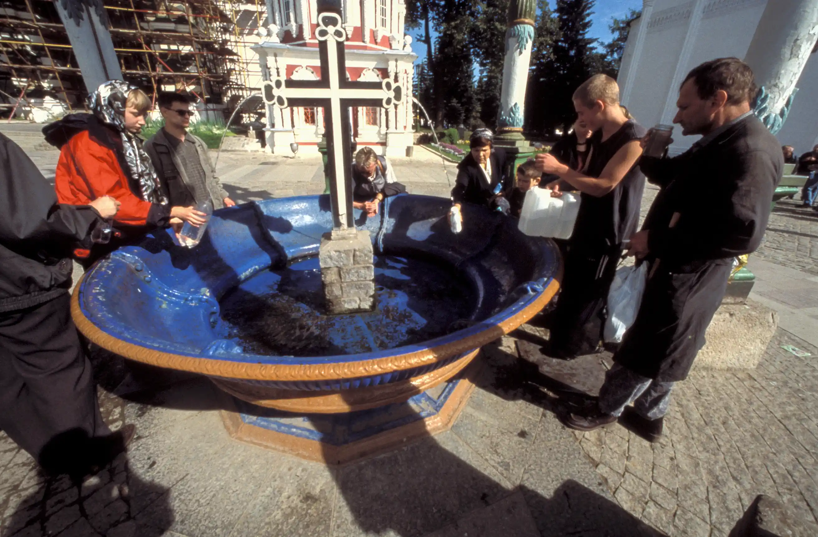 Pilgrims drinking and saving holy water, monastery of Sergiev Posad Pilgrims drinking and saving holy water, monastery of Sergiev Posad