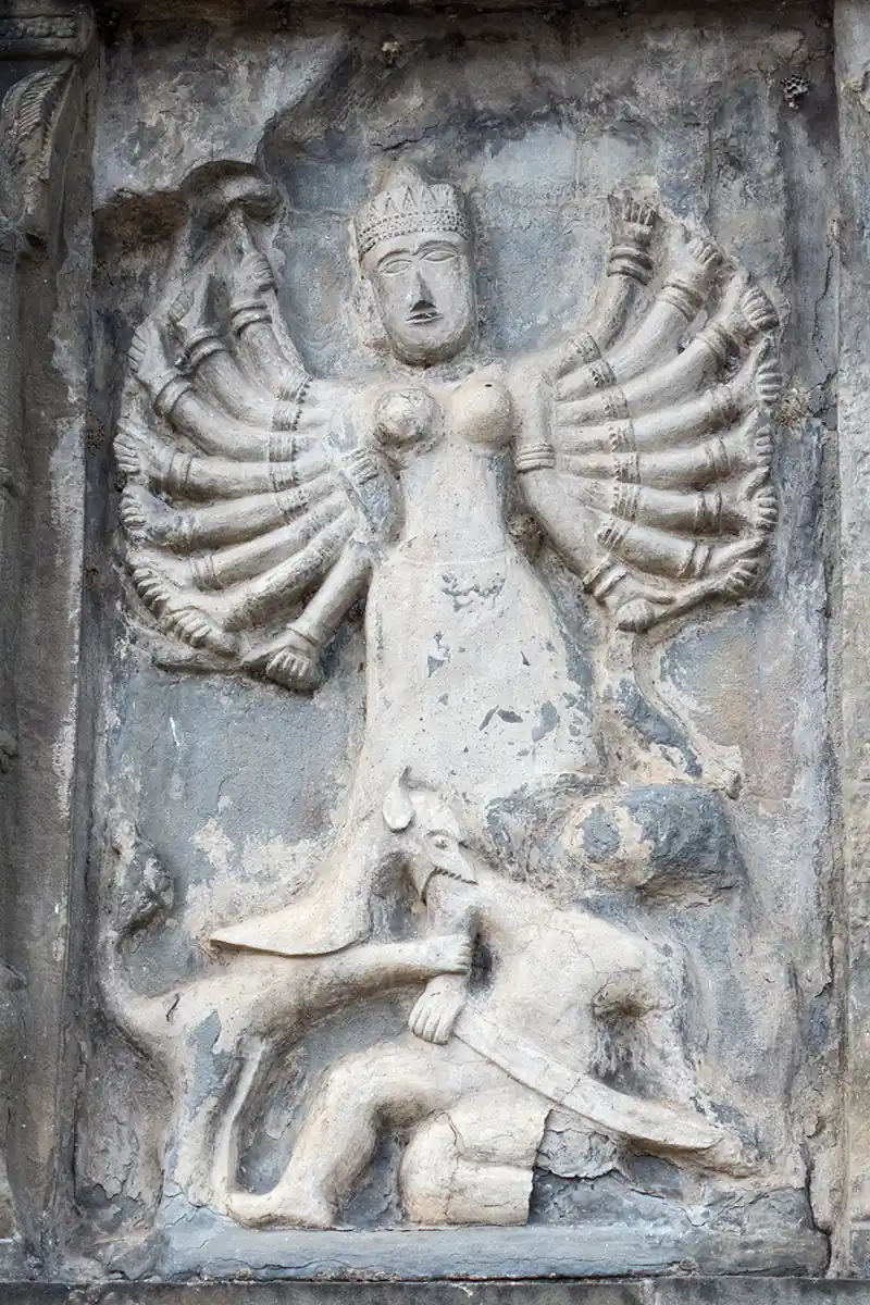 Carving of 16-armed goddess Durga killing buffalo-headed demon king Mahishasura, Sivadol Temple Carving of 16-armed goddess Durga killing buffalo-headed demon king Mahishasura, Sivadol Temple