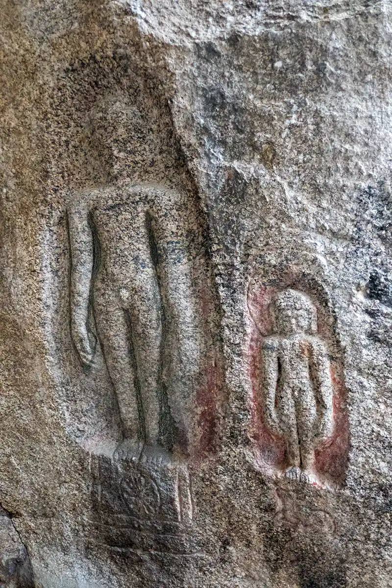 Cave wall carved with figure of Jain Tirthankara Adinatha Cave wall carved with figure of Jain Tirthankara Adinatha