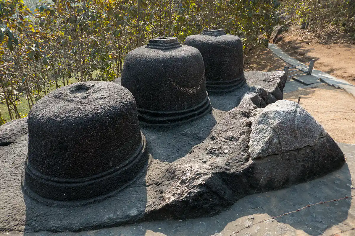 Three Buddhist votive stupas carved from single boulder Three Buddhist votive stupas carved from single boulder