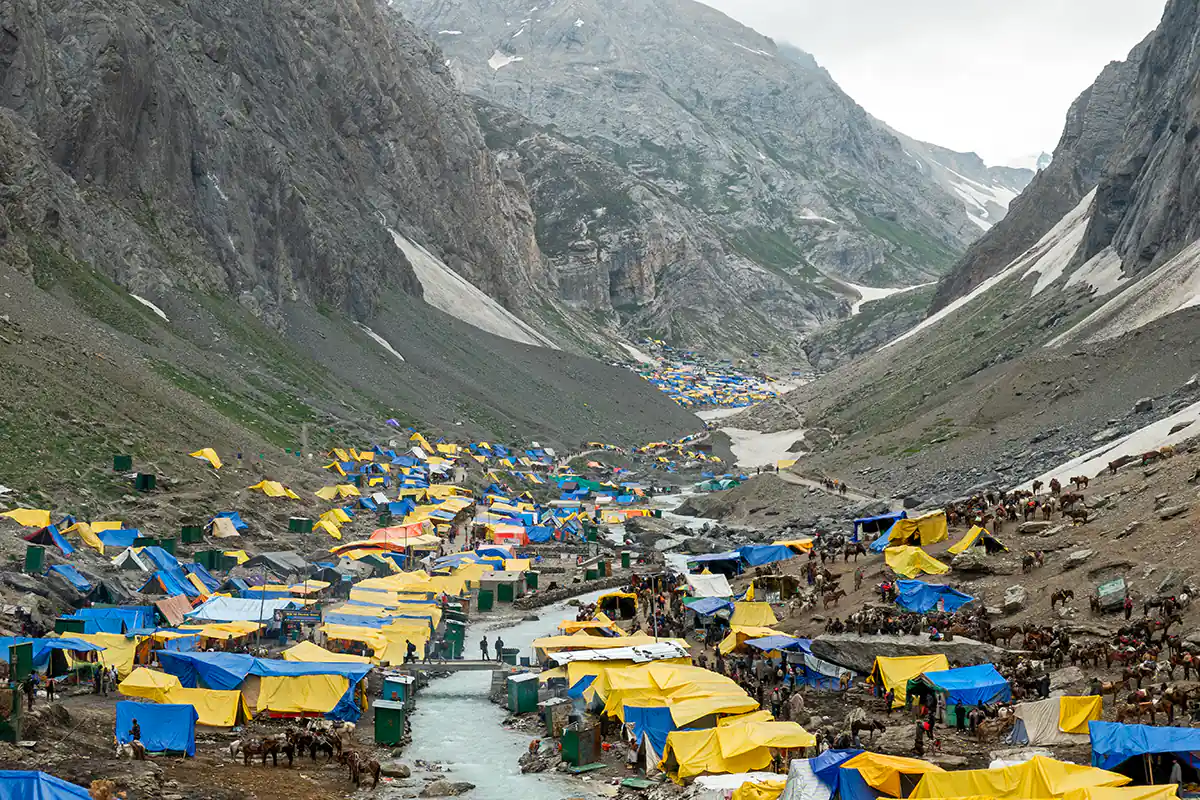 Tents for pilgrims near Amarnath Shiva Cave Temple, cave in distance at top of photograph Tents for pilgrims near Amarnath Shiva Cave Temple, cave in distance at top of photograph