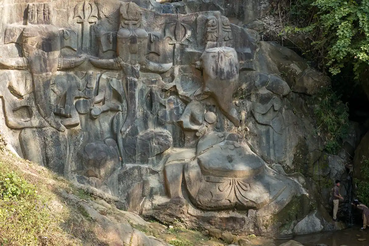 Three bas-relief sculptures of Ganesh on boulders and holy spring, Unakoti Three bas-relief sculptures of Ganesh on boulders and holy spring, Unakoti